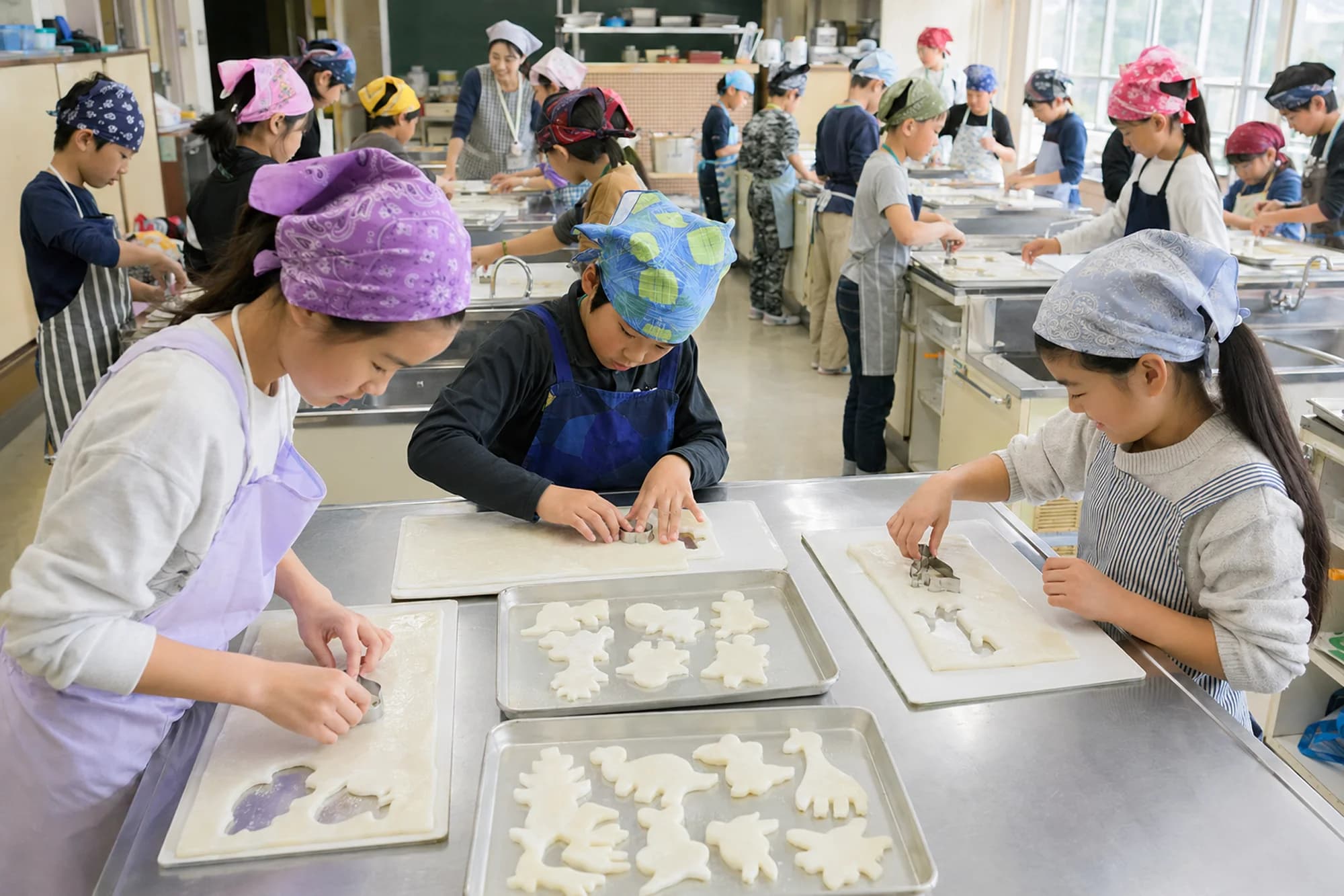 学校の調理室にて、板餅の型抜き作業風景のイメージ